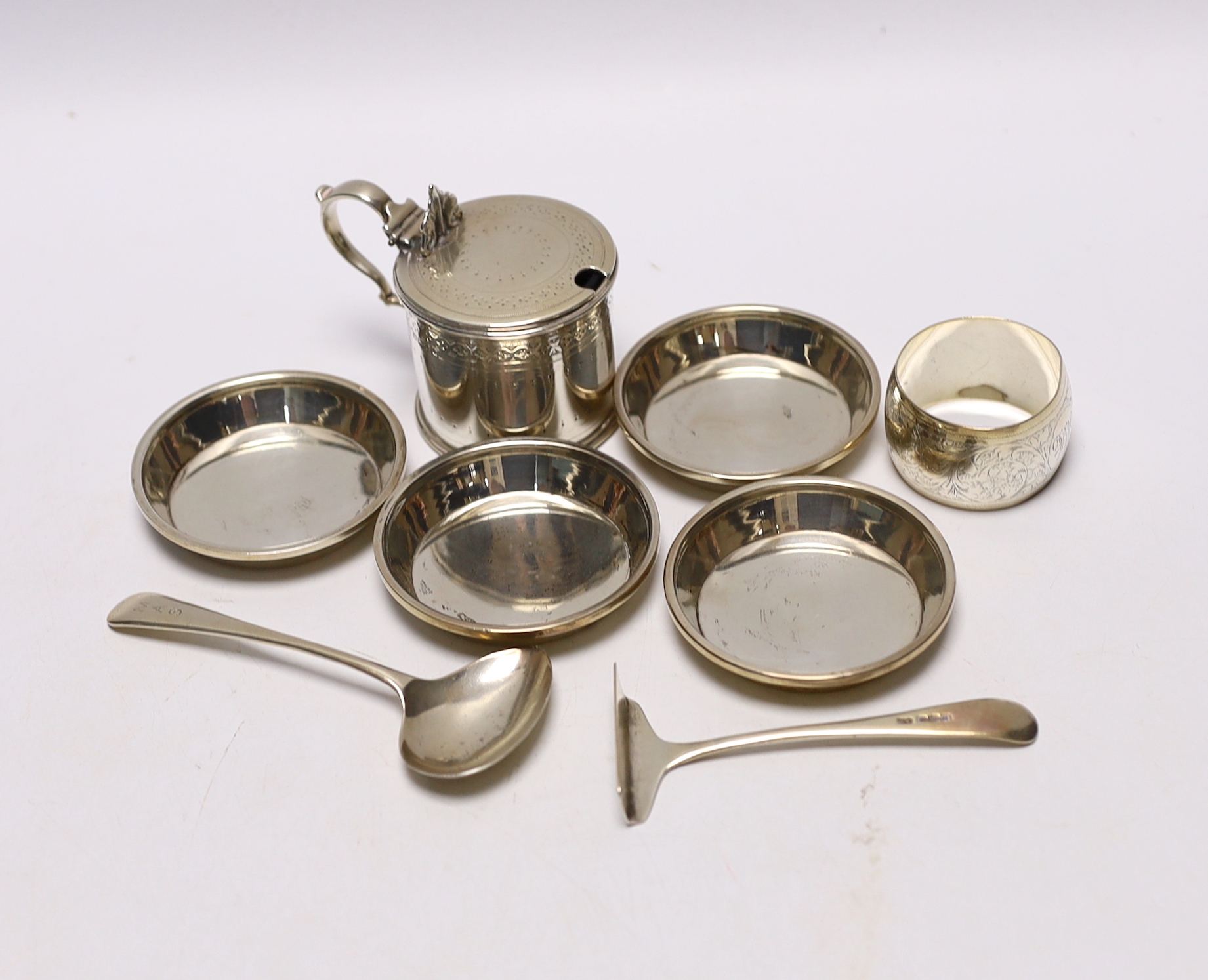 A Victorian silver mustard pot, Martin, Hall & Co, Sheffield, 1885, a set of four small silver dishes by Walker & Hall, a silver spoon & pusher and a silver napkin ring.